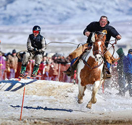 A man is riding a horse in a snowy field while another man is skiing nearby. AI generated content